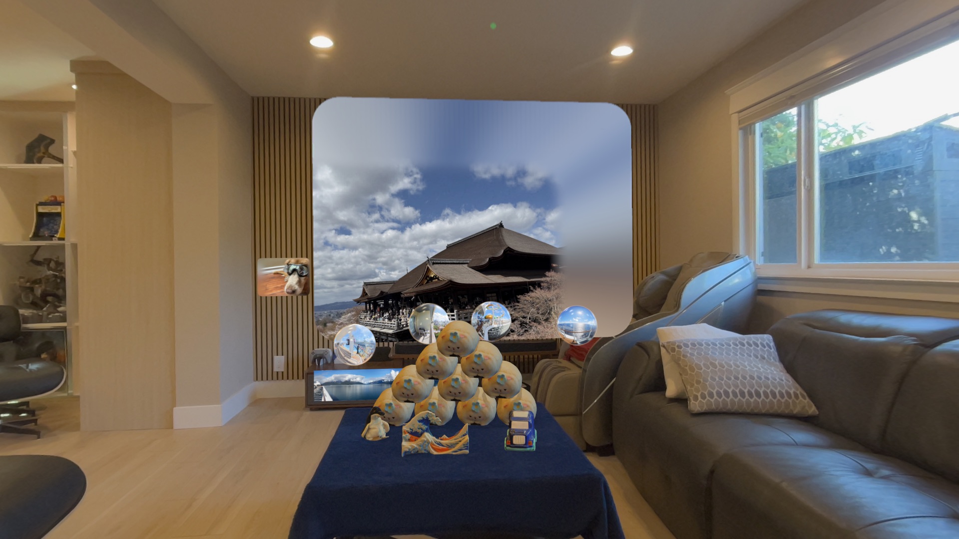 Full room AR gallery on Apple Vision Pro with 3D objects on table, photos on walls, and panorama portal